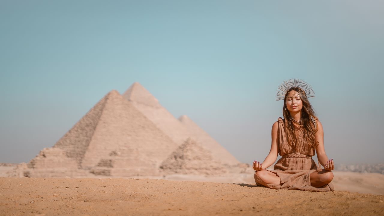 Sahara Rose meditating in front of the pyramids