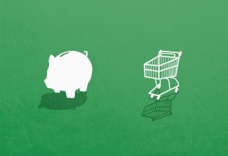 Piggy bank and shopping cart against green background
