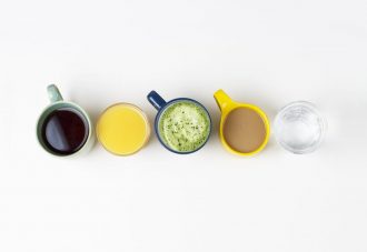 coffee-tea-and-other-drinks-in-colorful-cups-on-a-white-background-top-view
